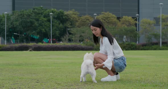 Woman play with her dog at park