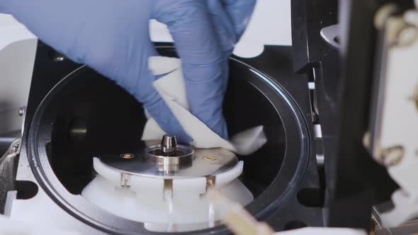 Close Up Scientist Cleaning an Ion Source of Mass Spectrometer with Lint Free Cloth and Solvent