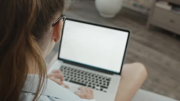 Teenage Student Girl in Glasses Works at Laptop, Types Text, Prepares for Exams, Studies Information