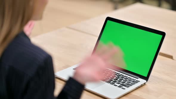 Rear View of Businesswoman Using Laptop with Chroma Screen