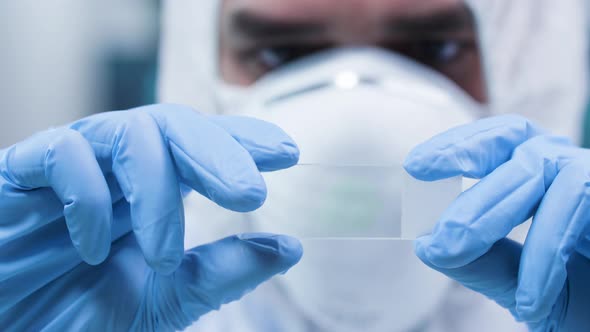 Static Shot of Researcher in White Coverall Analyzing a Sample