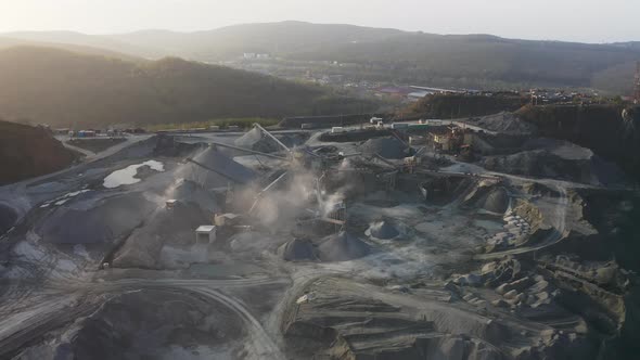 Big Crusher Working with Rubble at a Quarry Moving It on a Line