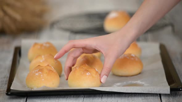 Delicious Freshly Baked Yeast Buns with Crust on Baking Sheet