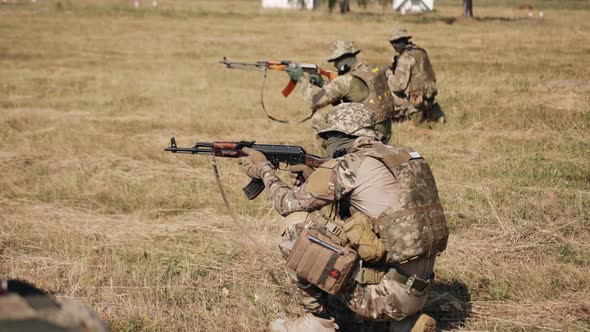 Group of Soldiers with Ammunition and Weapons on the Battlefield Attempting to Attack the Enemy