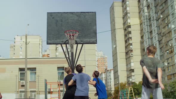 Streetball Player Shooting for Two Points on Court