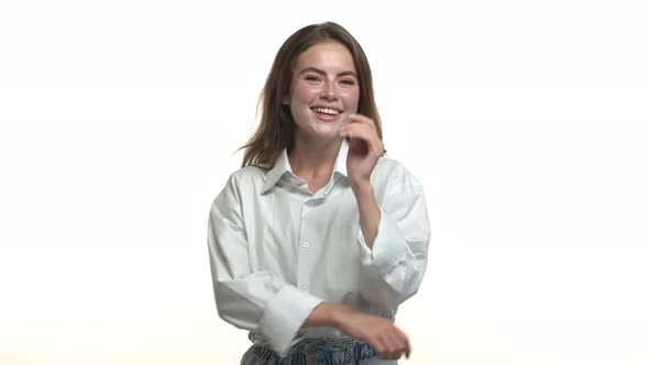 Video of Young Coquettish Woman in Shirt Collar Shirt Looking Seductive and Winking at Camera