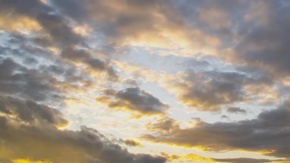 Time lapse of fast moving clouds on dark blue sky at sunset.