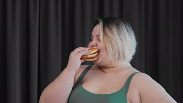 Smiling Fat Woman Holding a Burger and Eating It  Body Positivity and Feminism