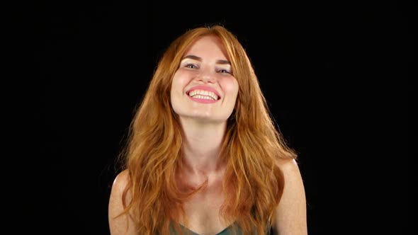 Girl Genuinely Smile at the Camera. Black Background