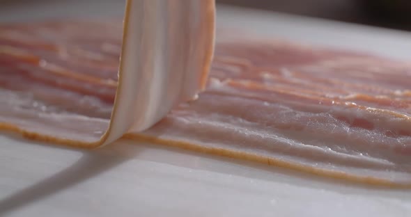 Chef Tooks Thin Slices of Smoked Bacon in Slow Motion