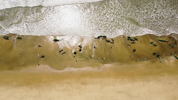 Typhoon washed out many fishing nets on sandy Vietnam coastline, aerial top down view