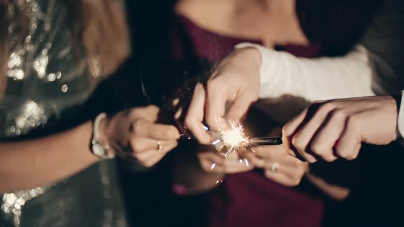 Hands or Palms on Black Background Seting Fire to Sparklers with Lighter or Fire Holding and Waving