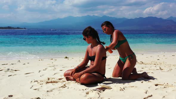 Sexy smiling ladies relaxing enjoying life on beach on paradise white sand and blue 4K background