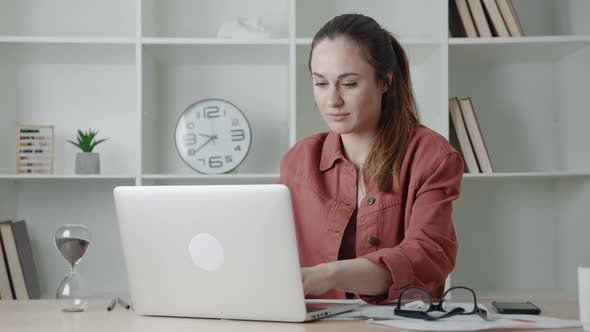 Businesswoman Sitting From the Desk and Looking Screen Laptop