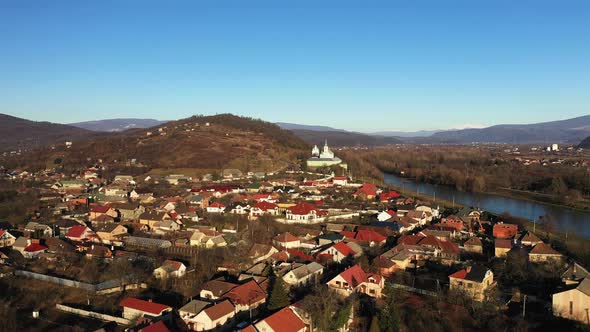 The Mukachevo City at the Evening with Beautiful Mountains Panorama Aerial View