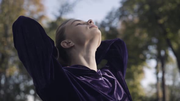 Closeup Face of Confident Sportswoman Making Ponytail