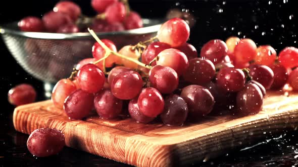 Water Falls on the Grapes on the Cutting Board