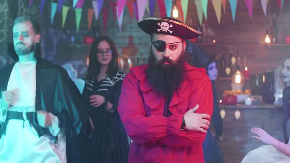 Portrait of a Handsome Bearded Man in Pirate Costume at a Halloween Party