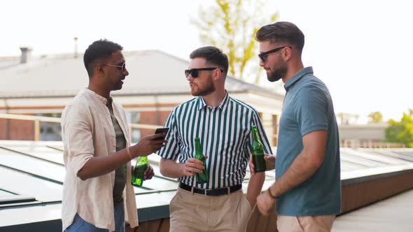 Men with Smartphone Drinking Beer on Rooftop