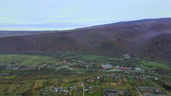 Aerial view in the mountain valley autumn landscape with small village