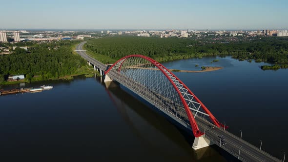 Road Bridge Against the Background of Green Forest and City