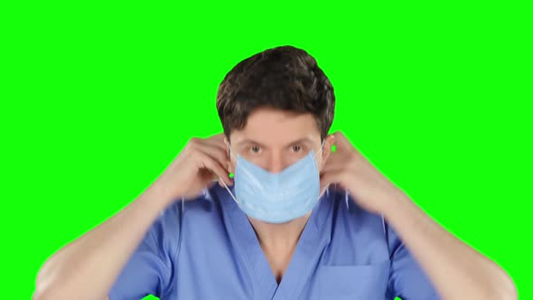 Doctor Puts on Protetcive Mask, Green Screen