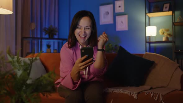 Excited Adult Woman Use Mobile Phone Browsing Online Say Wow Yes Found Out Great Big Win at Home