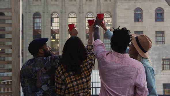 Young adult friends hanging out on a rooftop