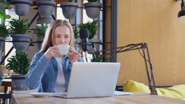 Influencer Drinking Coffee and Live Streaming on Laptop