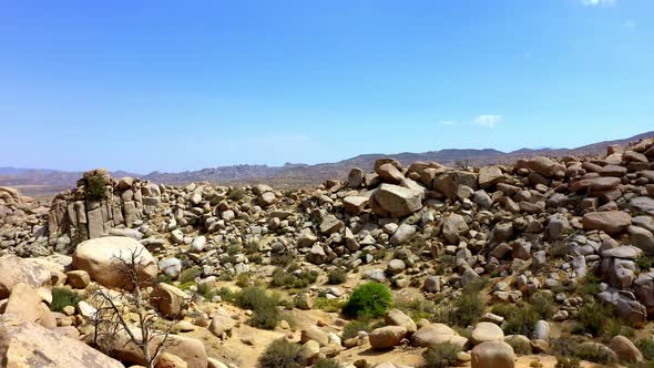 Drone shot flying towards the rocks of Boulder Gardens in Pioneertown, California.