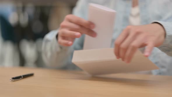 Male Hands Folding Letter and Giving It To Person Close Up