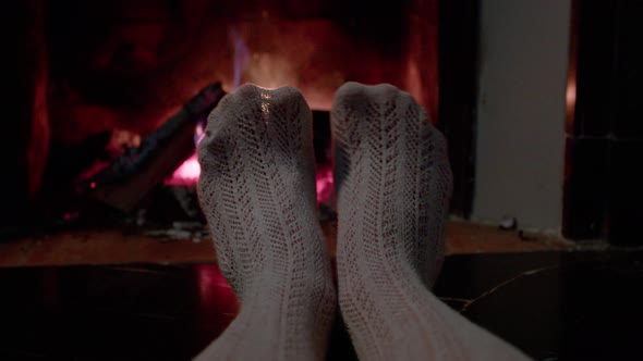 Woman's Legs in Pantyhose Getting Warm From Fireplace