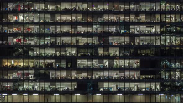 View of office windows with working people