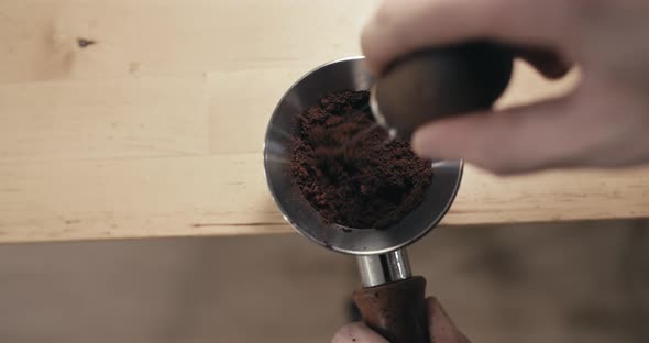 Barista Preparing Espresso Coffee Grinds with WDT Tool for Double Shot Extraction, Closeup of Weiss