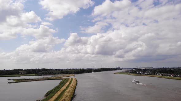 Aerial View Of River Noord With Fluffy Clouds In The Sky. Slow Dolly Forward