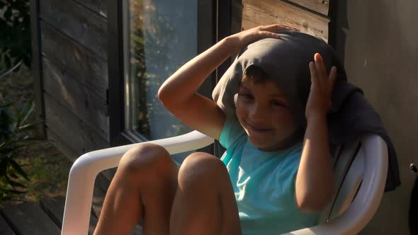 Boy Wipes His Head with a Towel