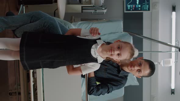 Vertical Video Portrait of Child and Mother Visiting Old Patient in Hospital Ward Bed