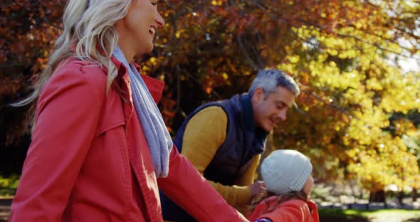 parents and daughter running outdoors