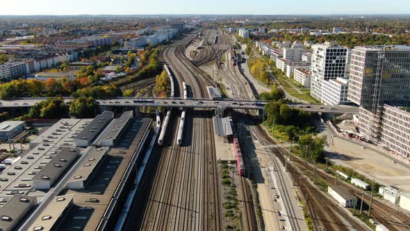 Aerial drone shot over railways and two trains running in opposite directions.