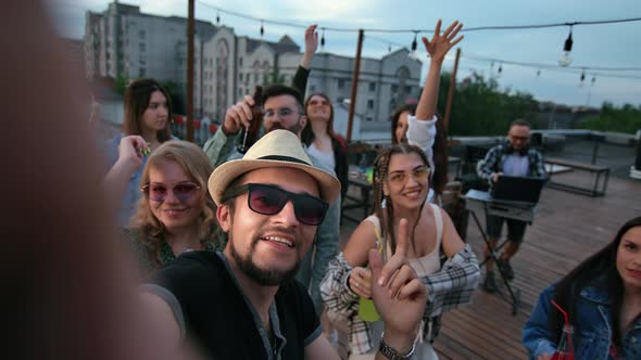 Overjoyed Hipster People Posing POV Selfie Dancing at Roof Night Party Together Positive Emotion