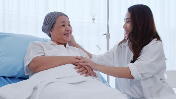 Young daughter encourages and comforts a mother with cancer during hospitalization.