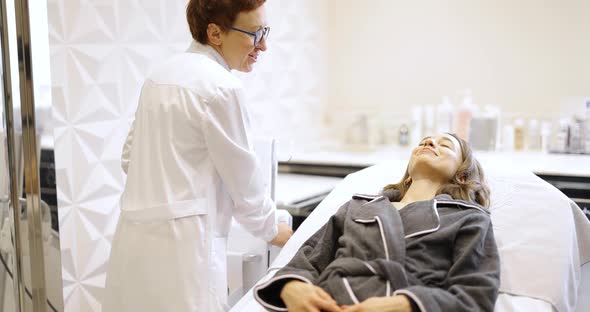 Woman on Ultrasound Face Lifting Procedure in Cosmetology Salon