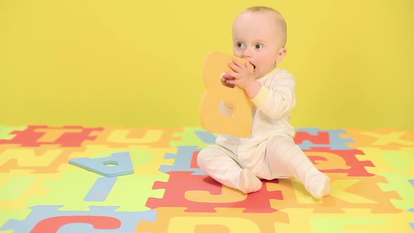 Baby boy playing with toy alphabet letters