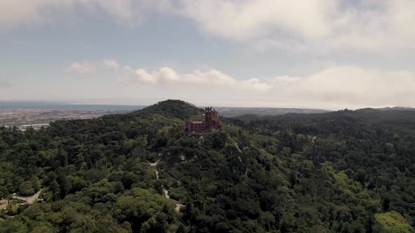 Panoramic panning shot on Sintra Hills overlooking at historic monument Pena palace and cloudscape.