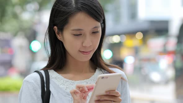 Woman use of cellphone in Hong Kong city