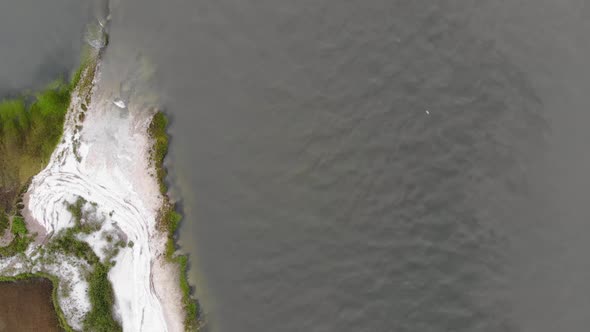 white sand beach coastline marsh ocean river waves tybee island georgia aerial drone