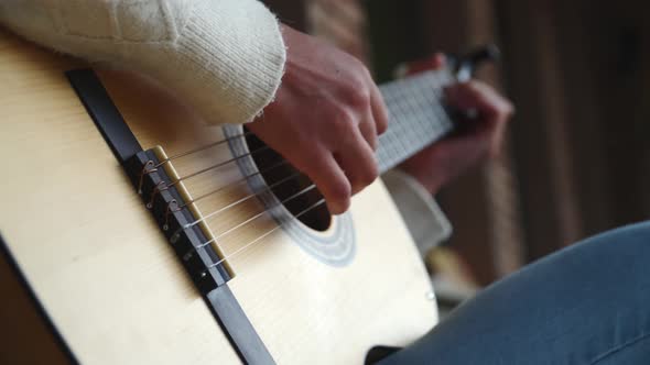 Close Up Of The Hands Of A Girl Palying The Guitar