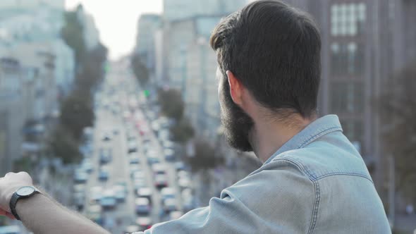 Handsome Bearded Man Smiling To the Camera Over His Shoulder