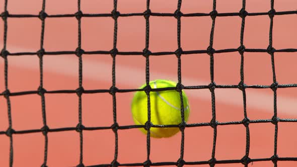 Super Slow Motion Shot of Tennis Ball Hitting the Net on Court at 1000Fps