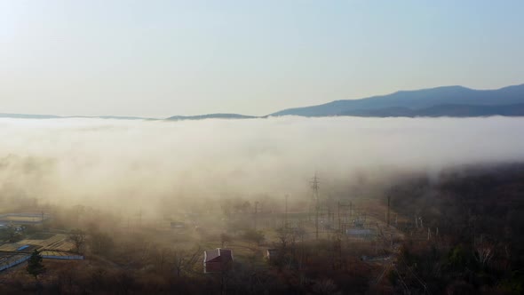 Flight Over the Valley Covered with Morning Mist in the Countryside